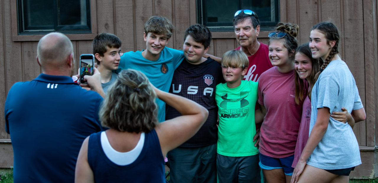 Family taking photo outside of cabin